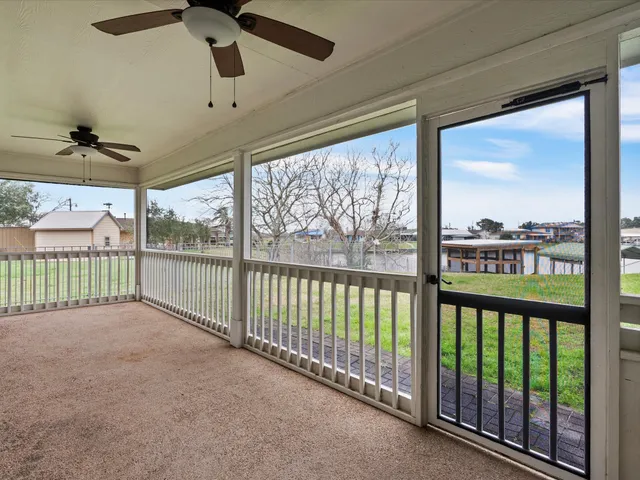 a view of a deck and floor to ceiling window