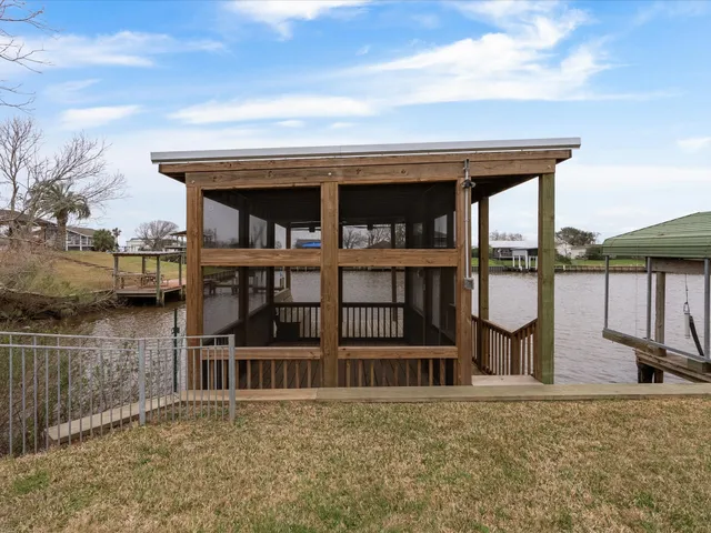 a view of a house with wooden floor next to a lake