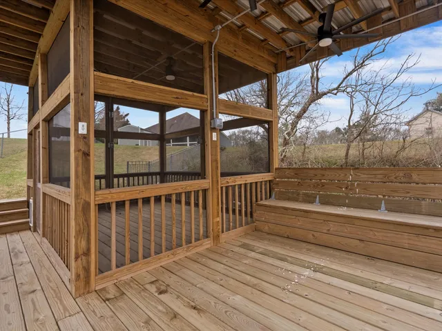 a view of a wooden deck with a glass door