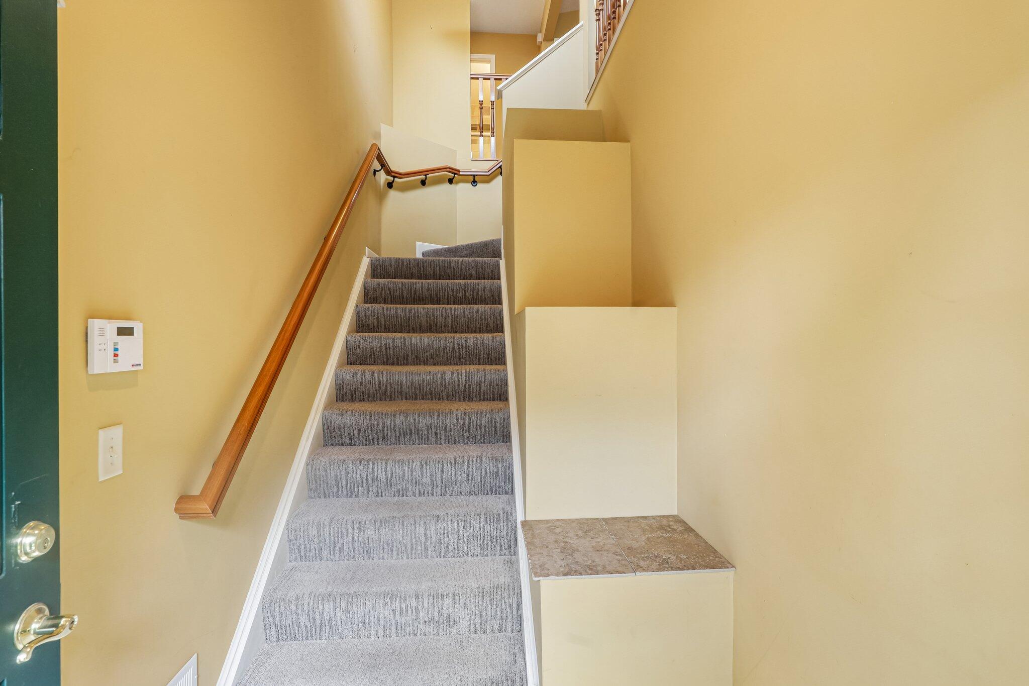876 Flint Ridge Newport, KY 41076 - Photo 12 of 43 Carpeted staircase with wood handrail, light yellow wall finish, and security panel
