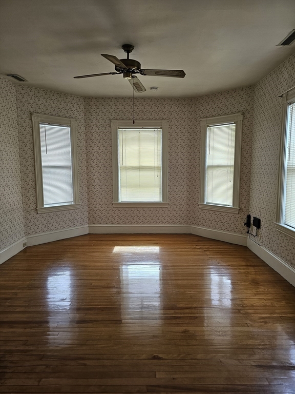 404 Stevens Street, Unit 2 Lowell, MA 01851 - Photo 11 of 12 a view of empty room with wooden floor and fan