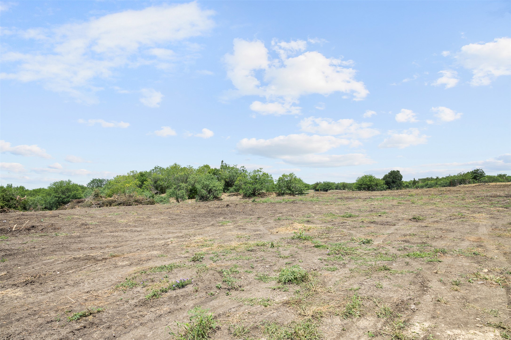 3315 Dry Creek Road Lockhart, TX 78644 - Photo 21 of 26 Cultivated land awaiting development with a clear sky backdrop.