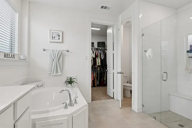 a bathroom with a tub sink and shower