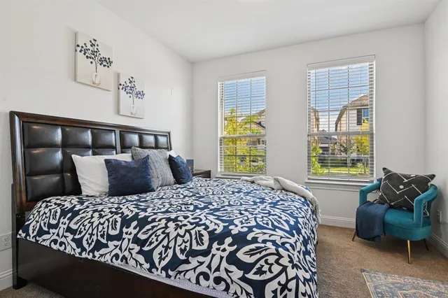 a bedroom with a large bed and a window