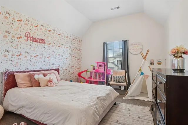 a bed room with a bed and a chair