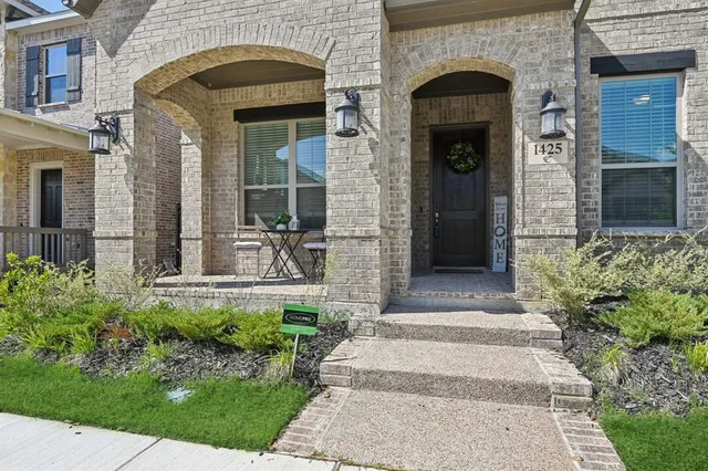 a front view of a house with potted plants