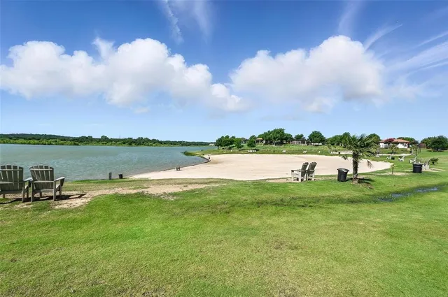 a view of a lake with houses in the back