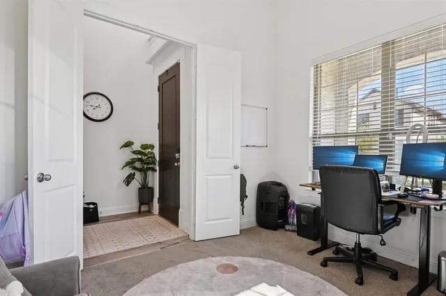 a view of a workspace with furniture and a window