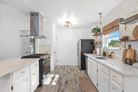 a kitchen with a sink stove and refrigerator