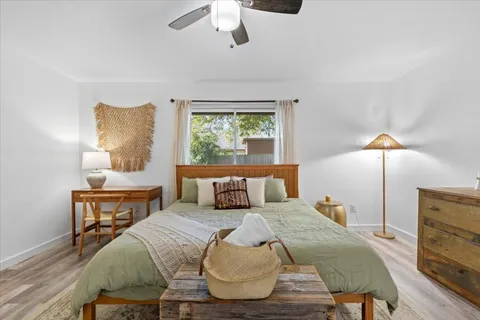 a bedroom with a bed a window and lamps