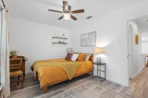 a bedroom with a bed and a chandelier