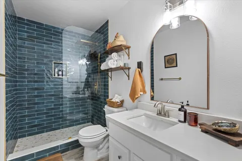 a bathroom with a toilet sink and mirror