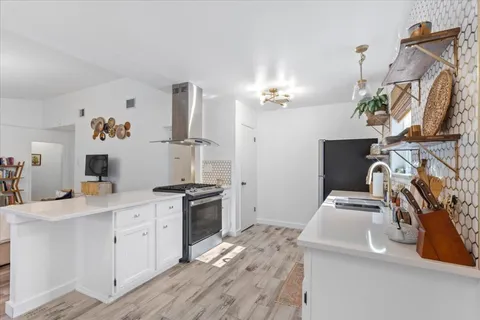 a kitchen with a sink stove and refrigerator