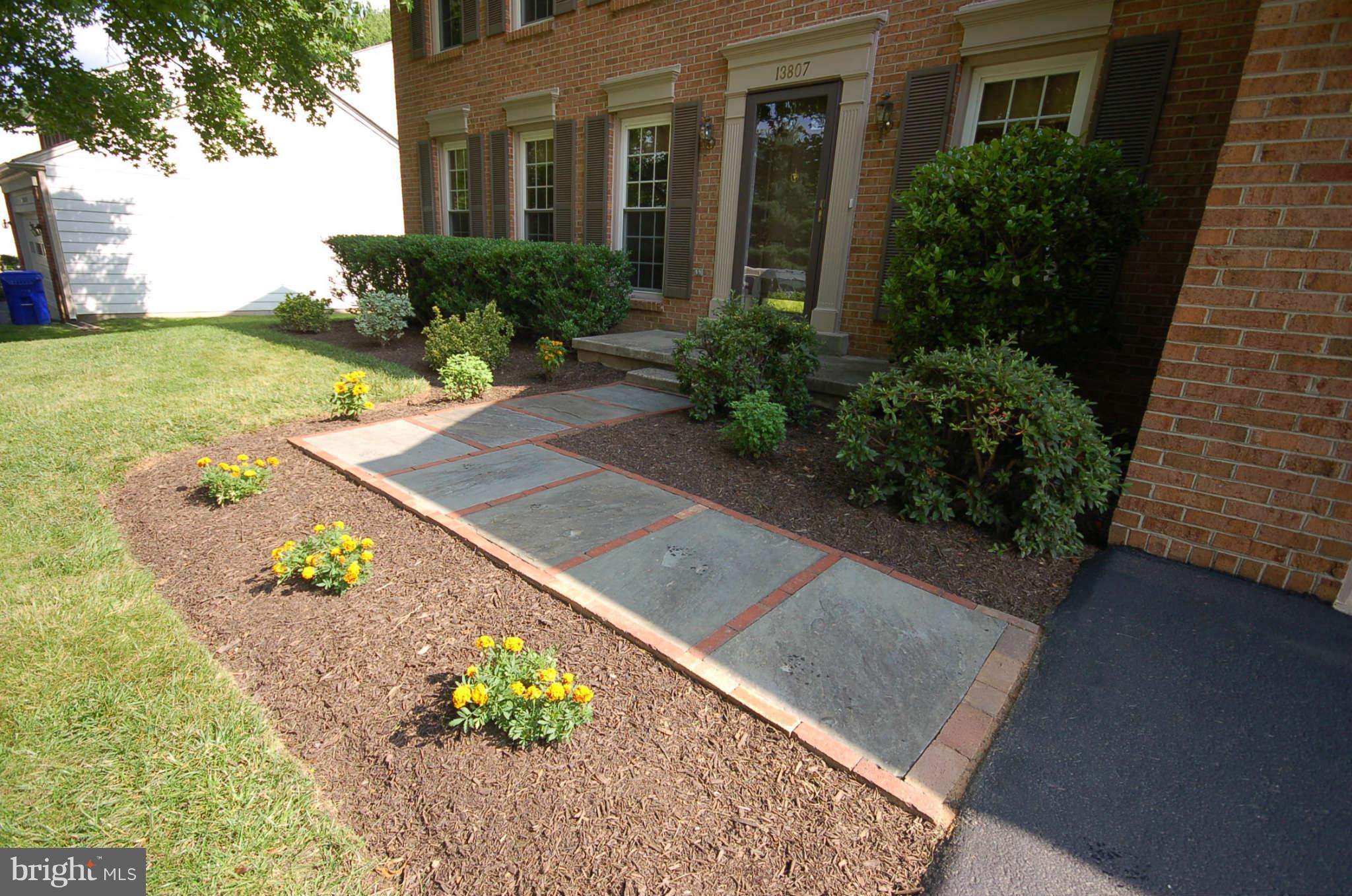 13807 Turnmore Road Silver Spring, MD 20906 - Photo 3 of 26 a front view of a house with a garden