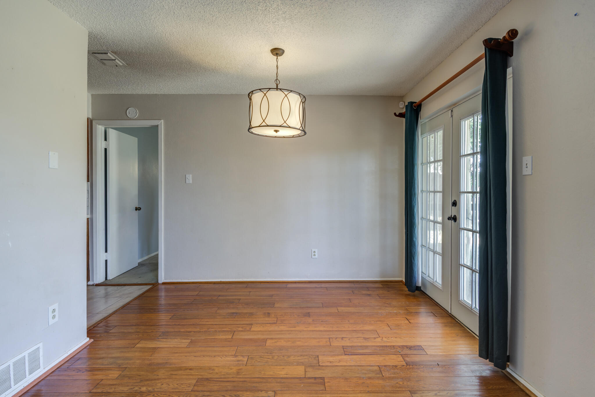 5018 70th Street Lubbock, TX 79424 - Photo 11 of 27 a view of empty room with wooden floor and window