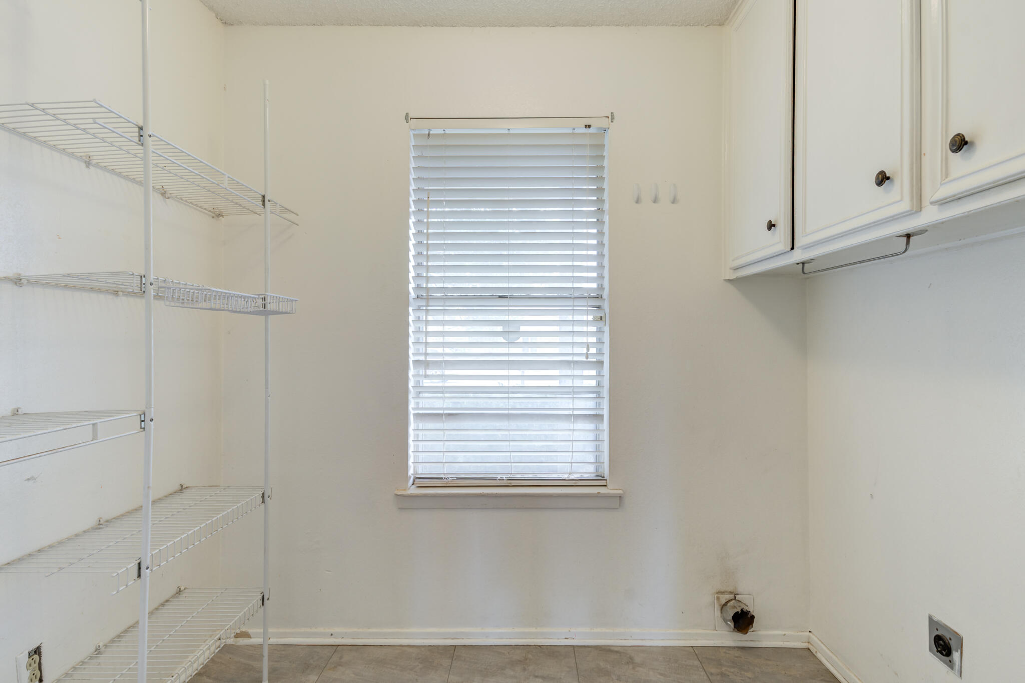 5018 70th Street Lubbock, TX 79424 - Photo 14 of 27 a view of a closet area with white paint