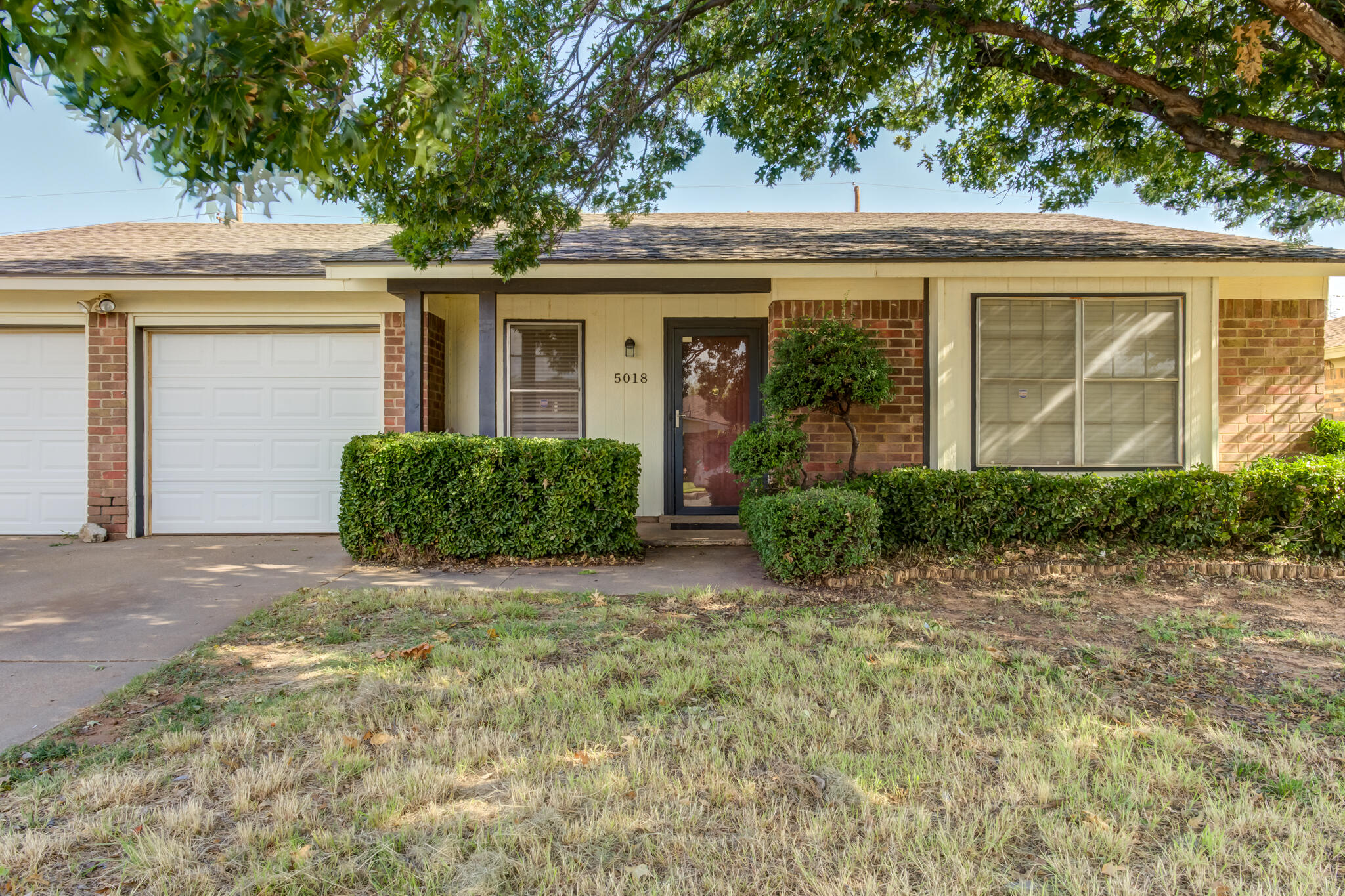 5018 70th Street Lubbock, TX 79424 - Photo 2 of 27 front view of a house with a small yard