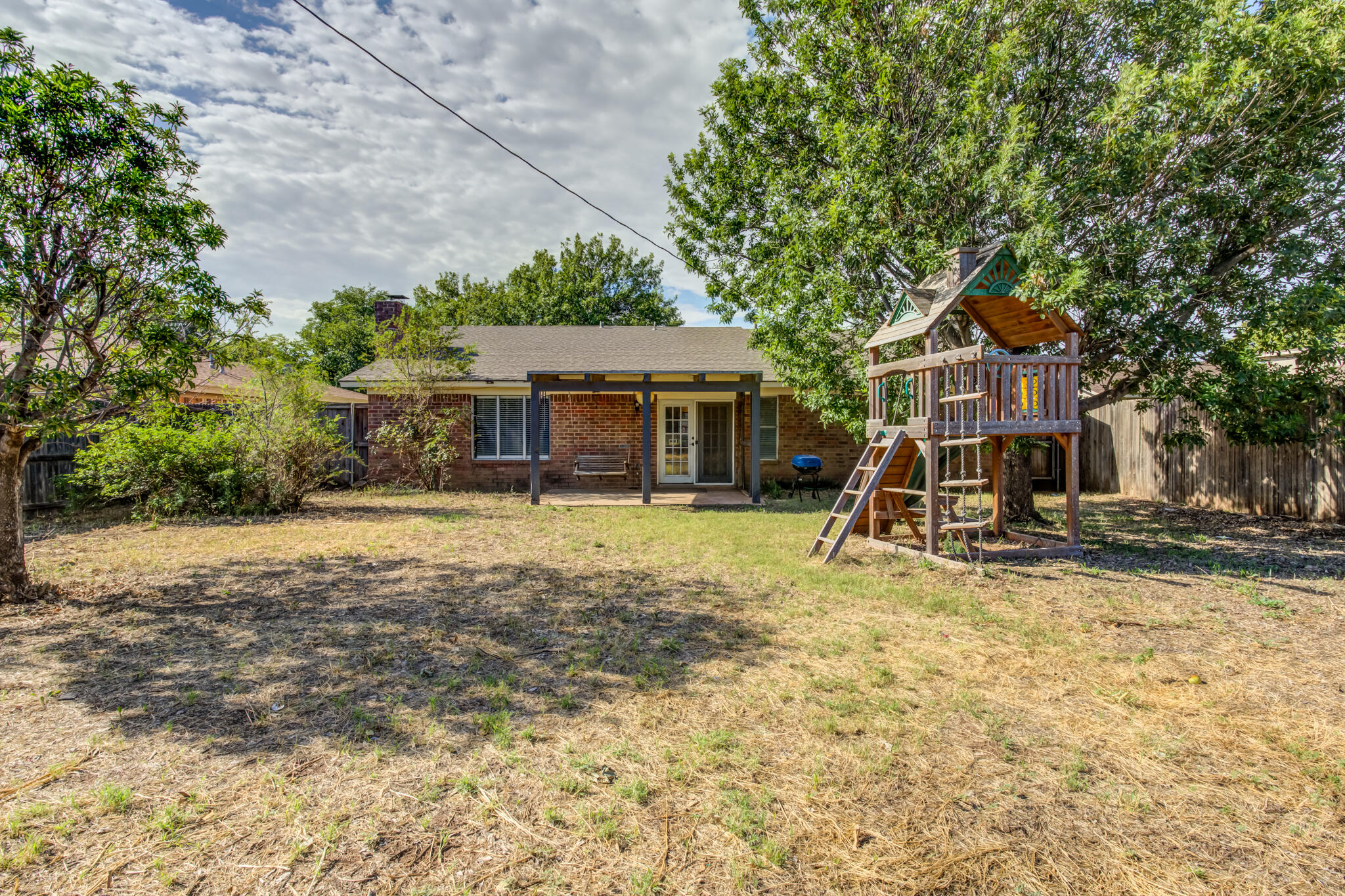 5018 70th Street Lubbock, TX 79424 - Photo 25 of 27 a view of a house with a yard and sitting area
