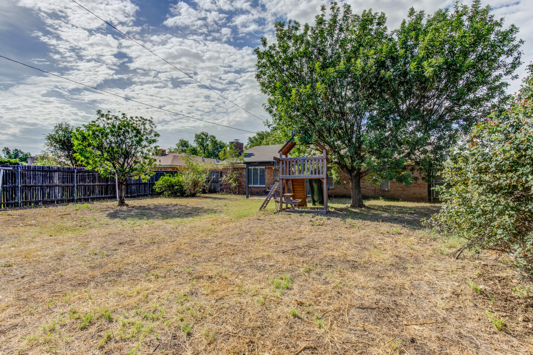 5018 70th Street Lubbock, TX 79424 - Photo 26 of 27 a view of a yard with a trampoline