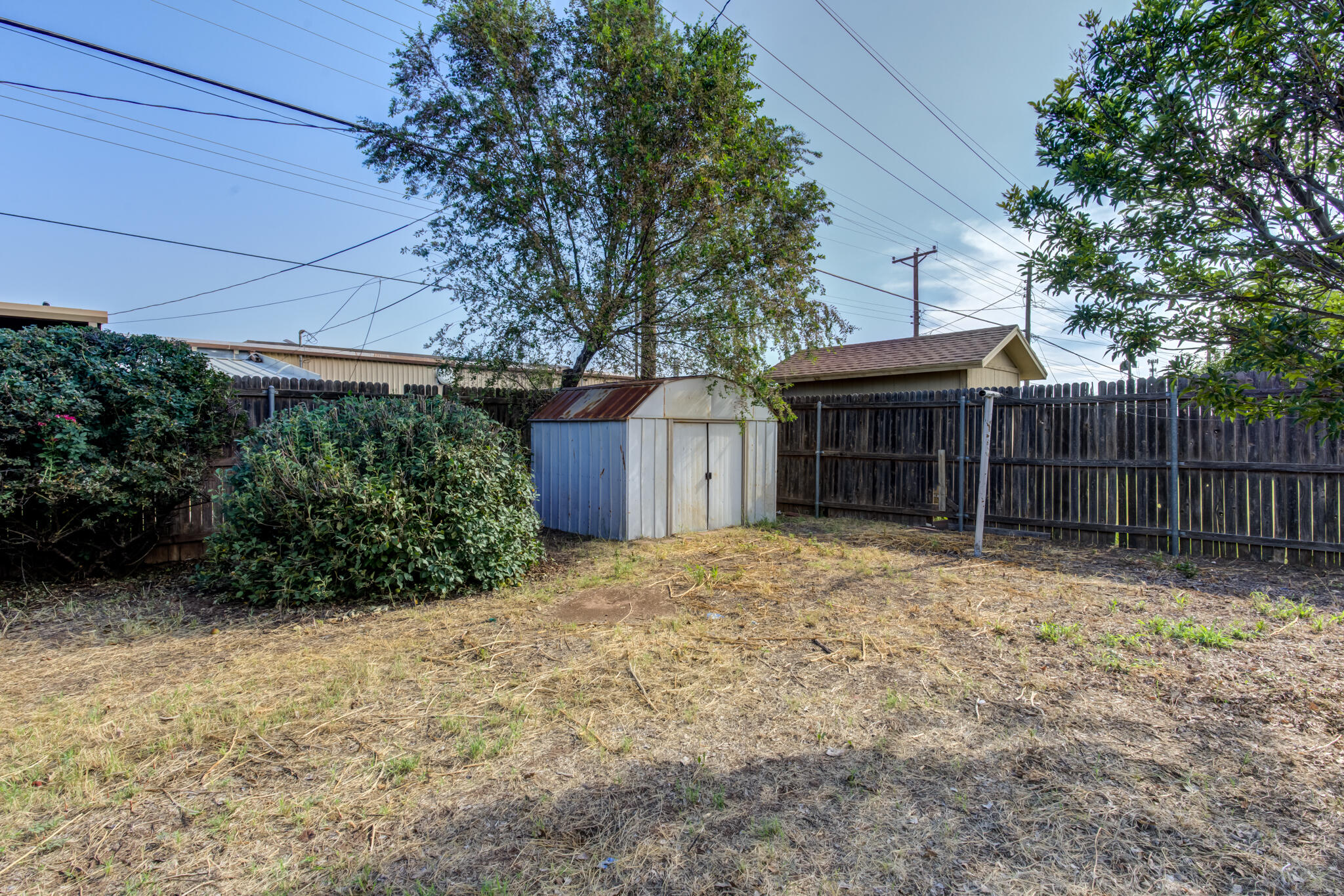 5018 70th Street Lubbock, TX 79424 - Photo 27 of 27 a view of a house with a yard and potted plants