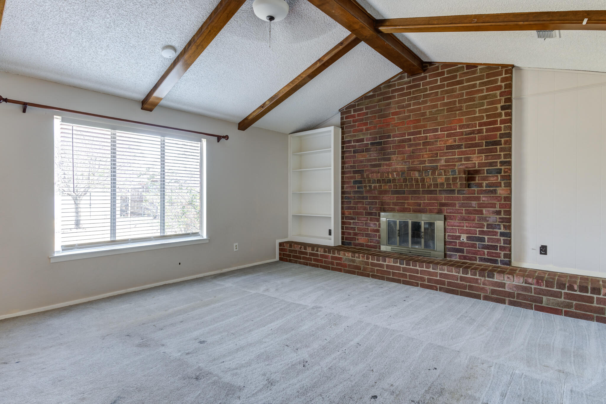 5018 70th Street Lubbock, TX 79424 - Photo 5 of 27 an empty room with a fireplace