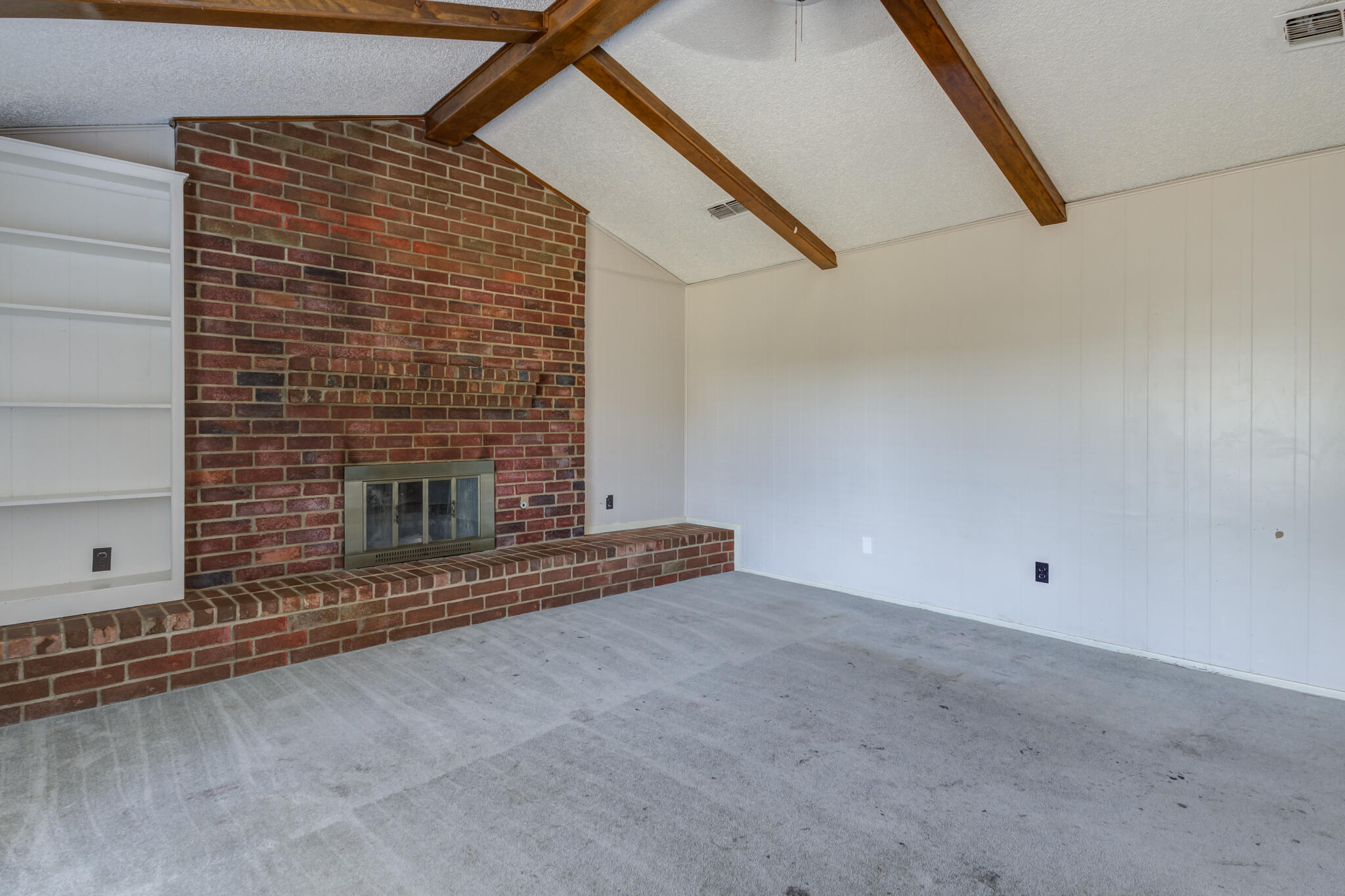 5018 70th Street Lubbock, TX 79424 - Photo 7 of 27 a view of an empty room with a fireplace