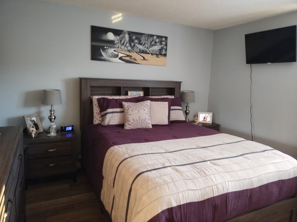 1475 Braley Road, Unit 17 New Bedford, MA 02745 - Photo 11 of 13 a bedroom with a bed and flat screen tv