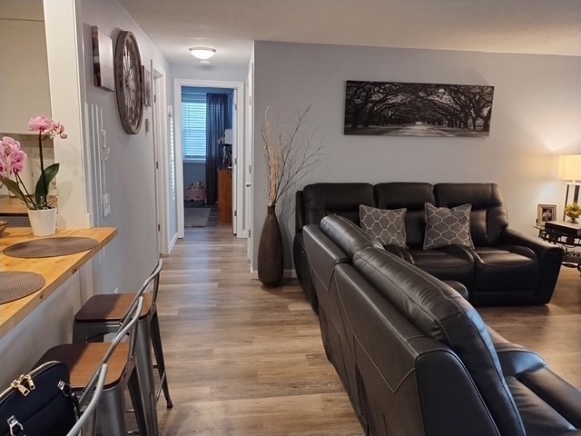 1475 Braley Road, Unit 17 New Bedford, MA 02745 - Photo 7 of 13 a living room with furniture and a wooden floor