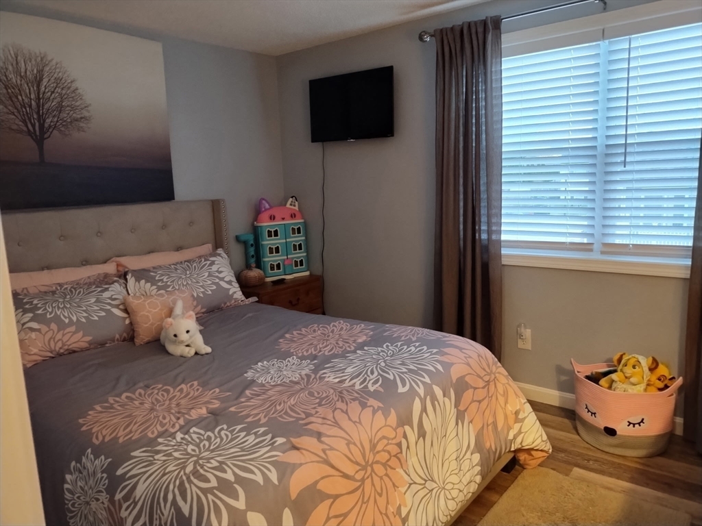 1475 Braley Road, Unit 17 New Bedford, MA 02745 - Photo 8 of 13 a bedroom with a bed and flat screen tv