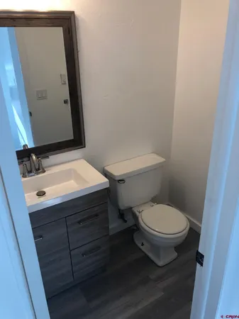 a view of street with yard and car parked