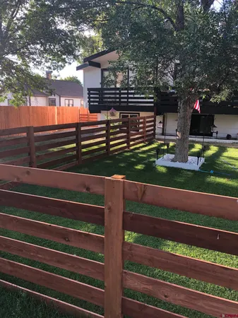 a room with a bed and wooden floor