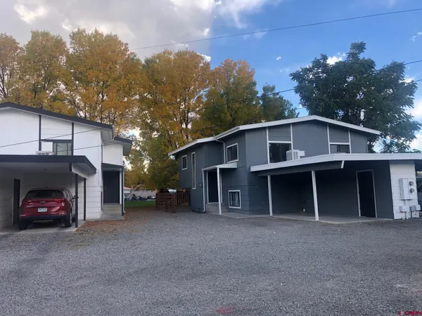 a view of a house with a yard and garage