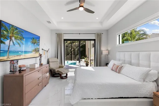 a large bedroom with a large bed and a large window