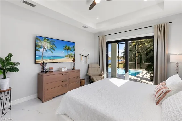 a bedroom with bed and large window