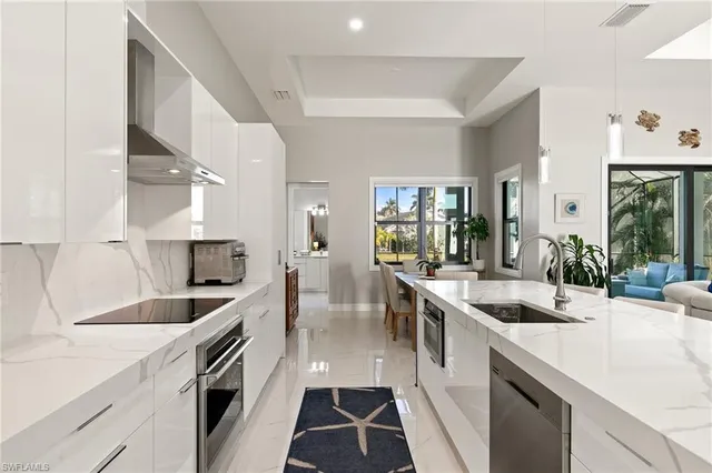 a kitchen with granite countertop a sink and stove top oven