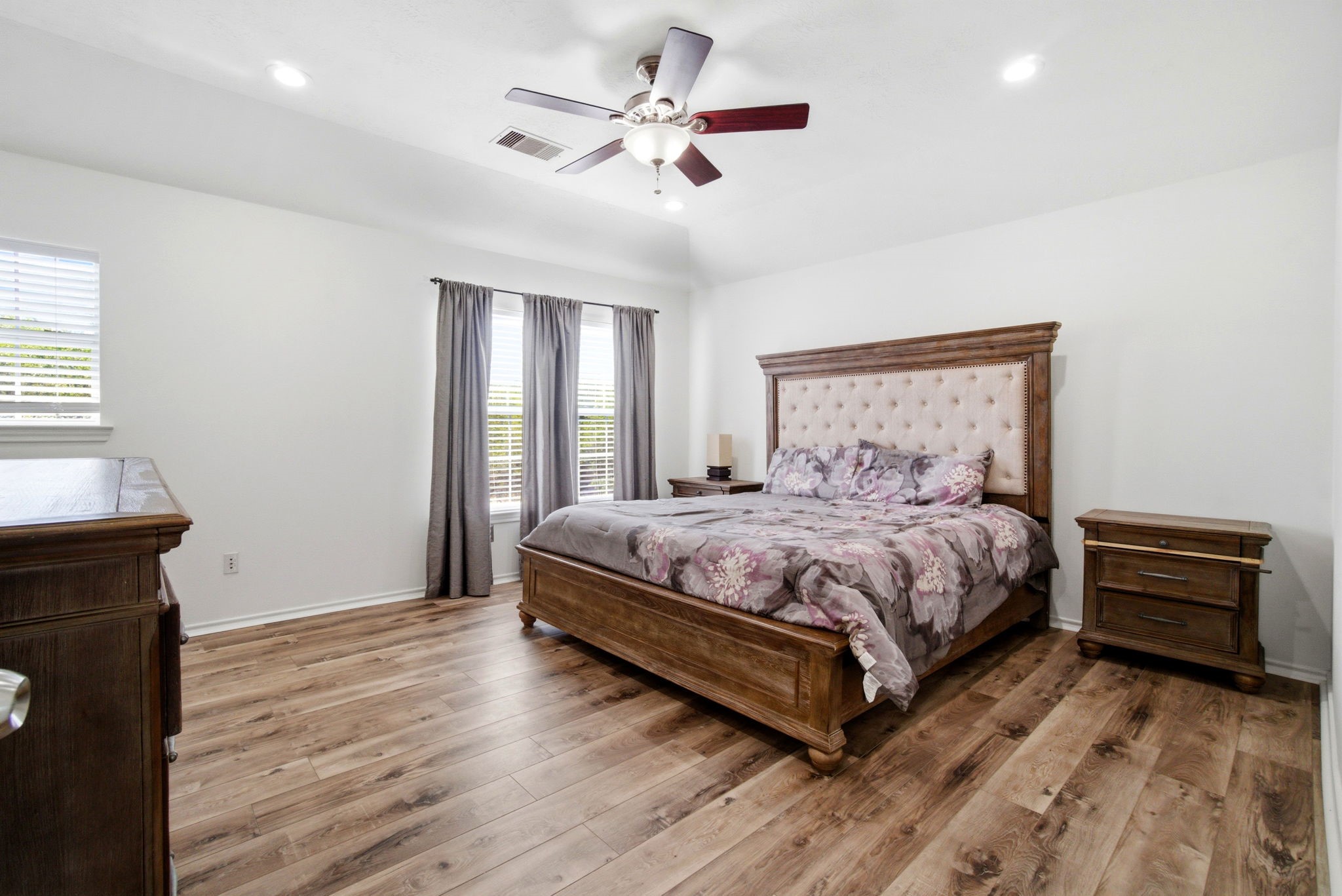 1607 Redbud Grove Court Conroe, TX 77301 - Photo 15 of 21 a bedroom with a bed and a chandelier