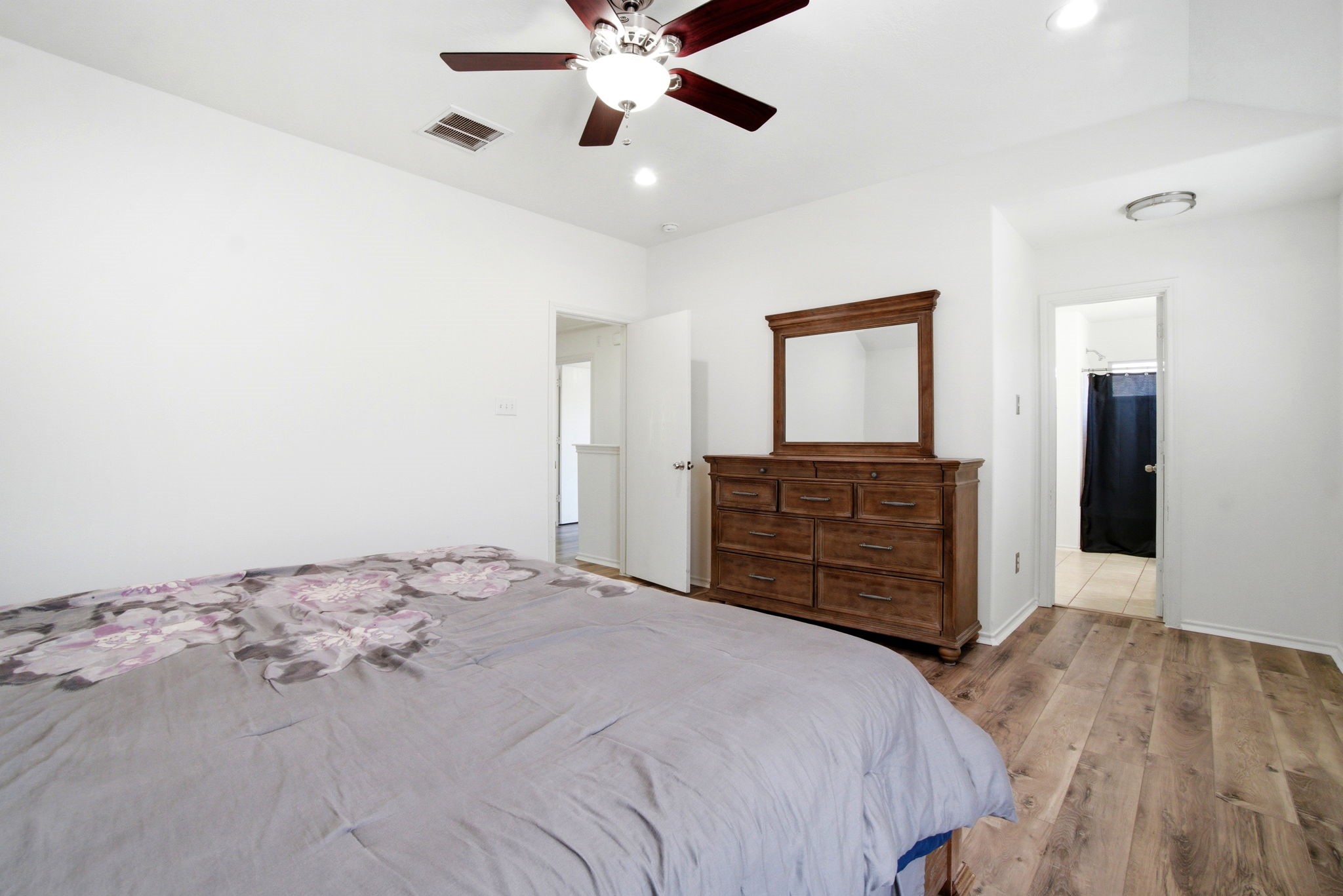1607 Redbud Grove Court Conroe, TX 77301 - Photo 16 of 21 a bedroom with a bed and a dresser