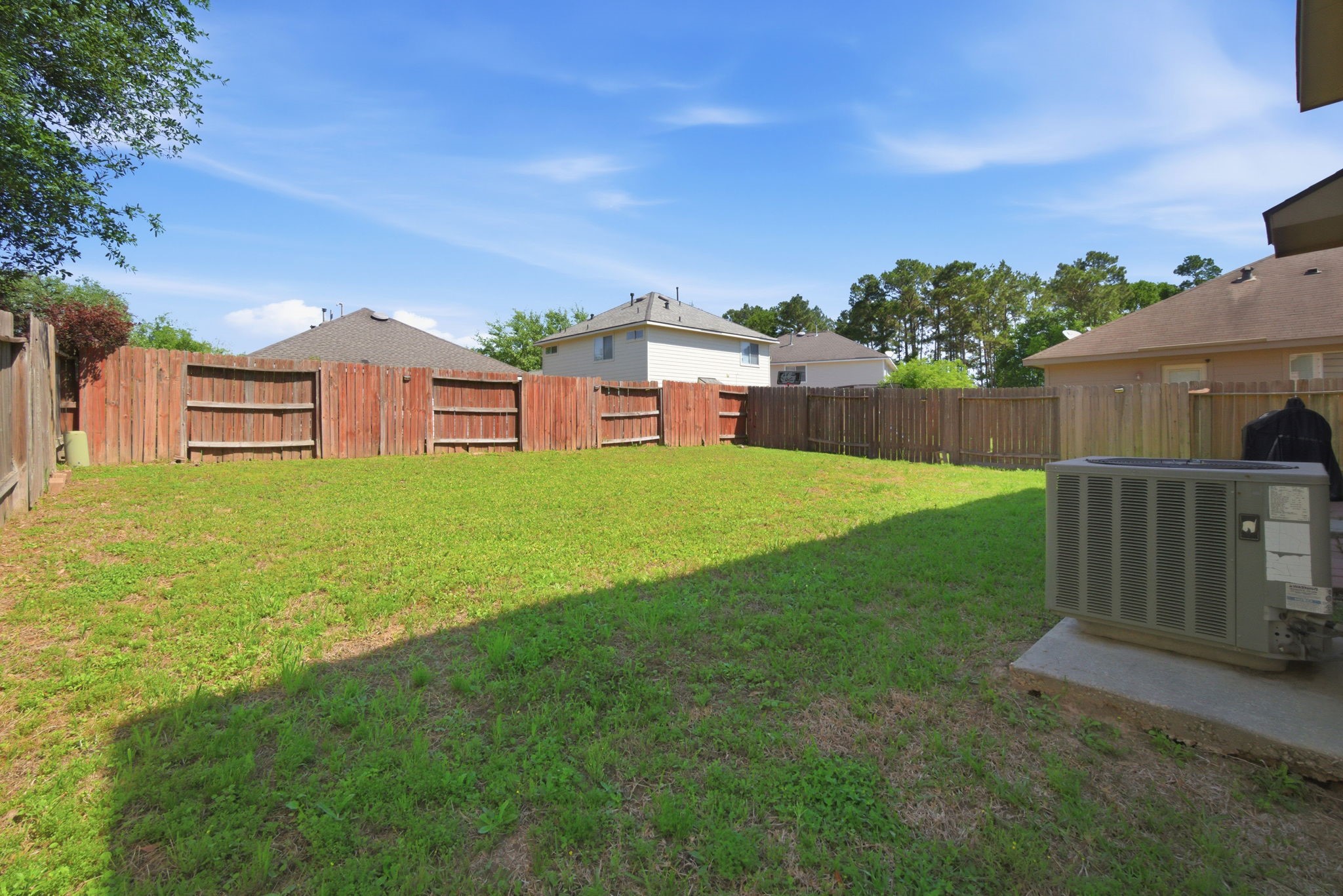 1607 Redbud Grove Court Conroe, TX 77301 - Photo 19 of 21 a view of a house with a yard and a porch