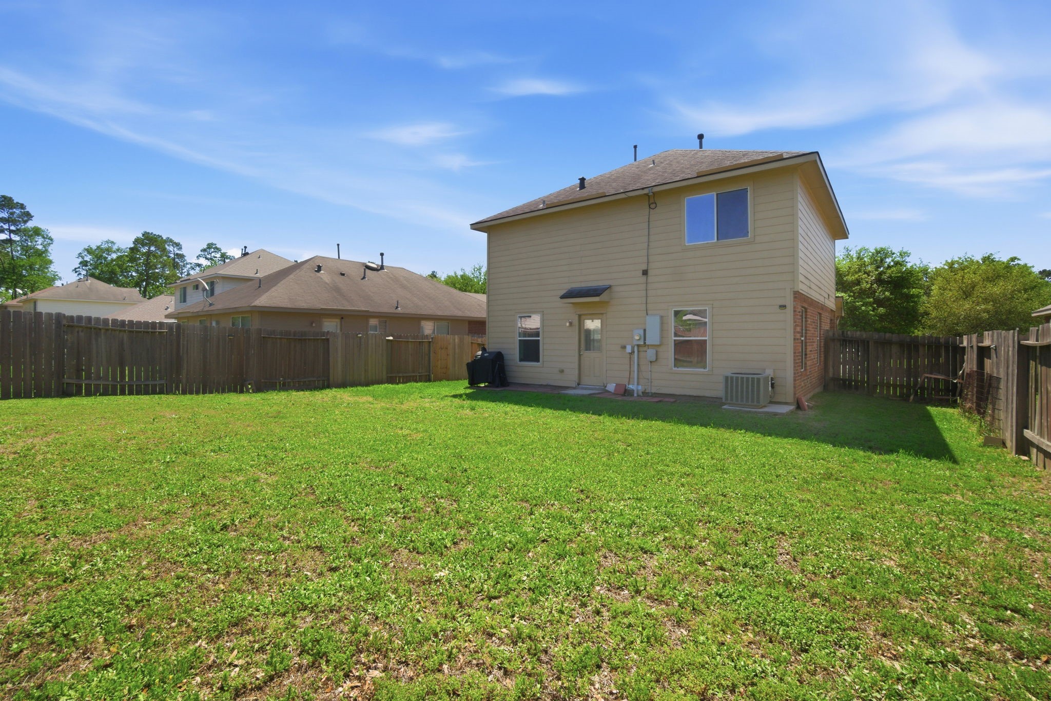 1607 Redbud Grove Court Conroe, TX 77301 - Photo 20 of 21 a view of a back yard of the house