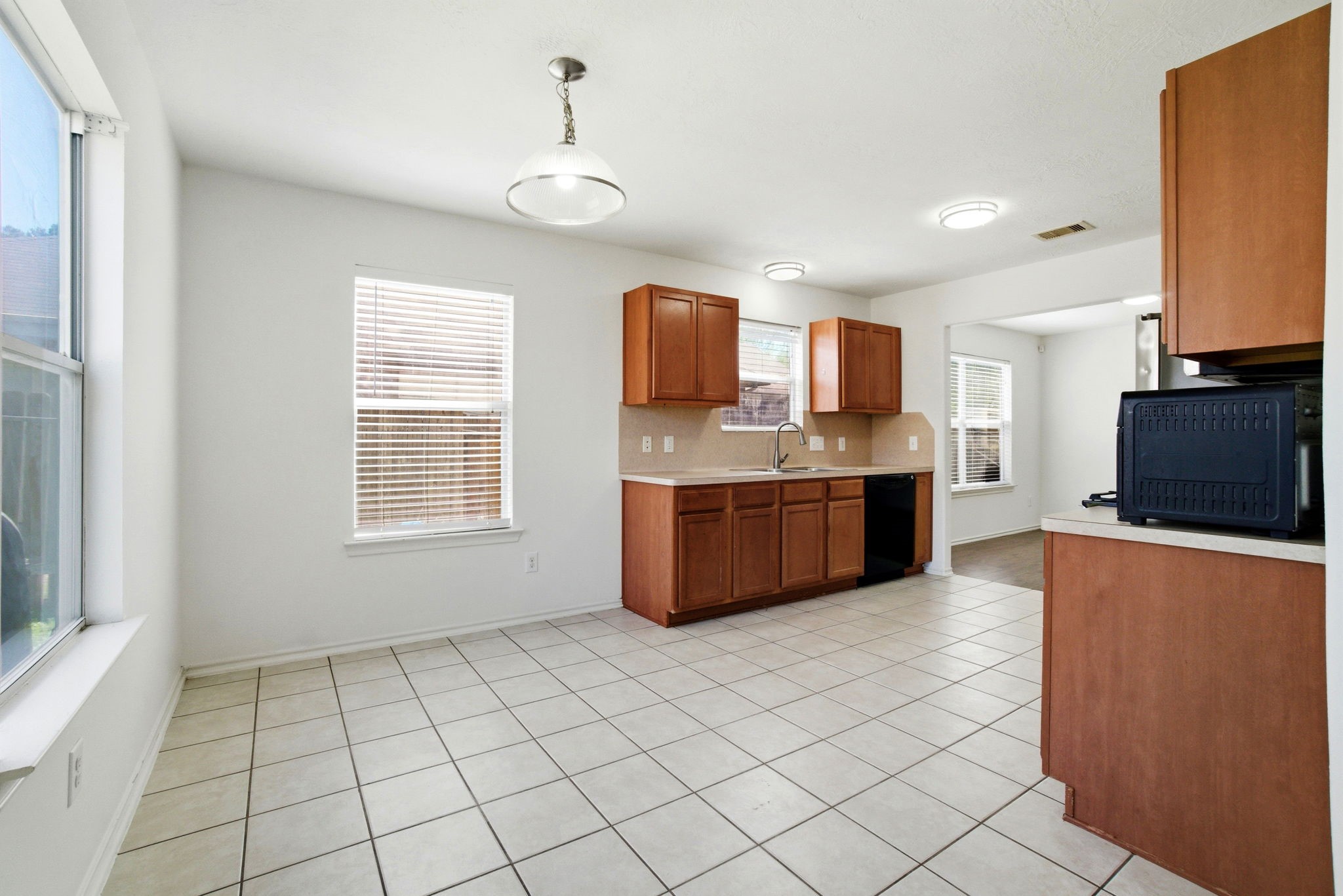 1607 Redbud Grove Court Conroe, TX 77301 - Photo 5 of 21 a kitchen with stainless steel appliances a sink and a stove top oven