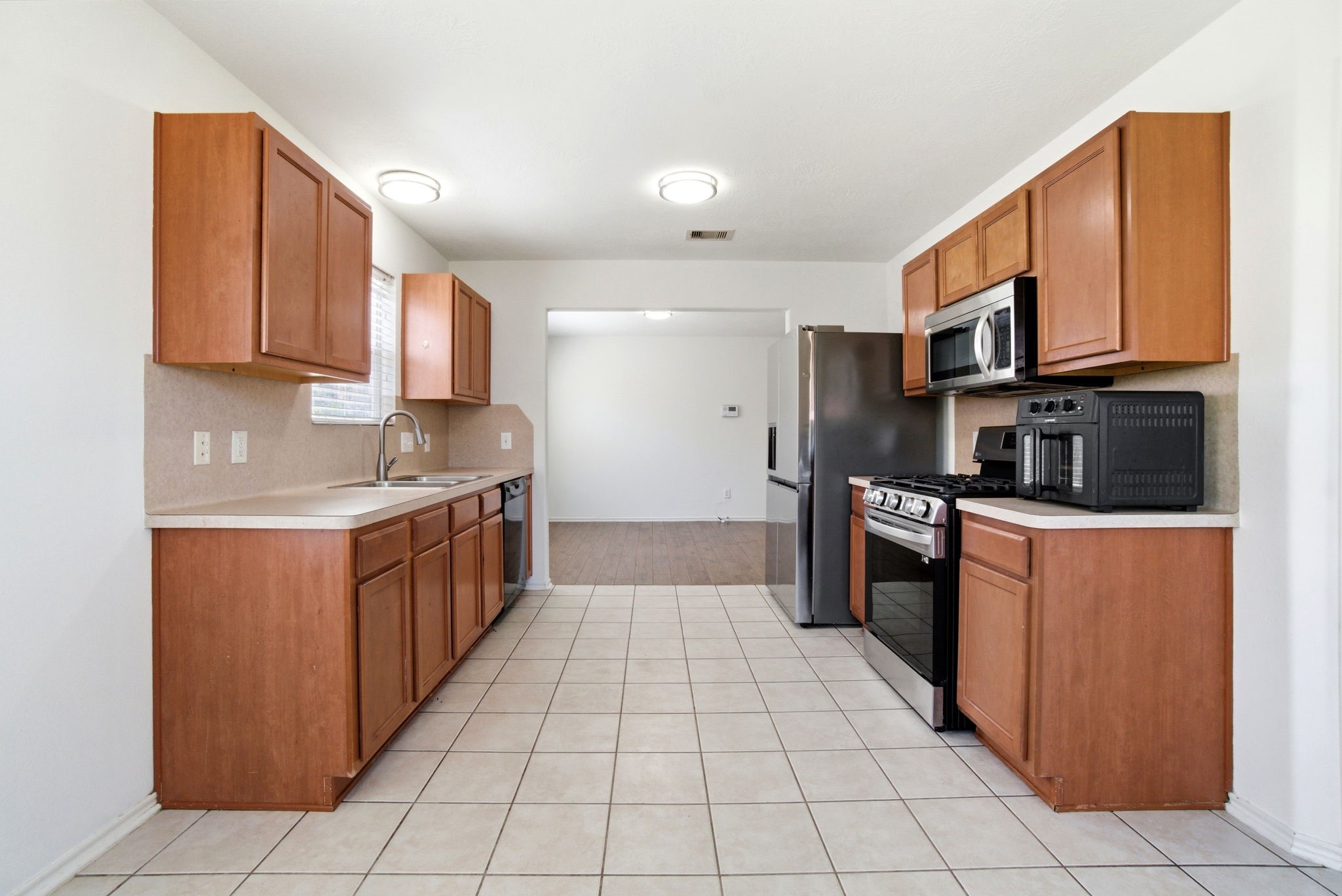 1607 Redbud Grove Court Conroe, TX 77301 - Photo 6 of 21 a kitchen with stainless steel appliances granite countertop a stove a sink and a refrigerator