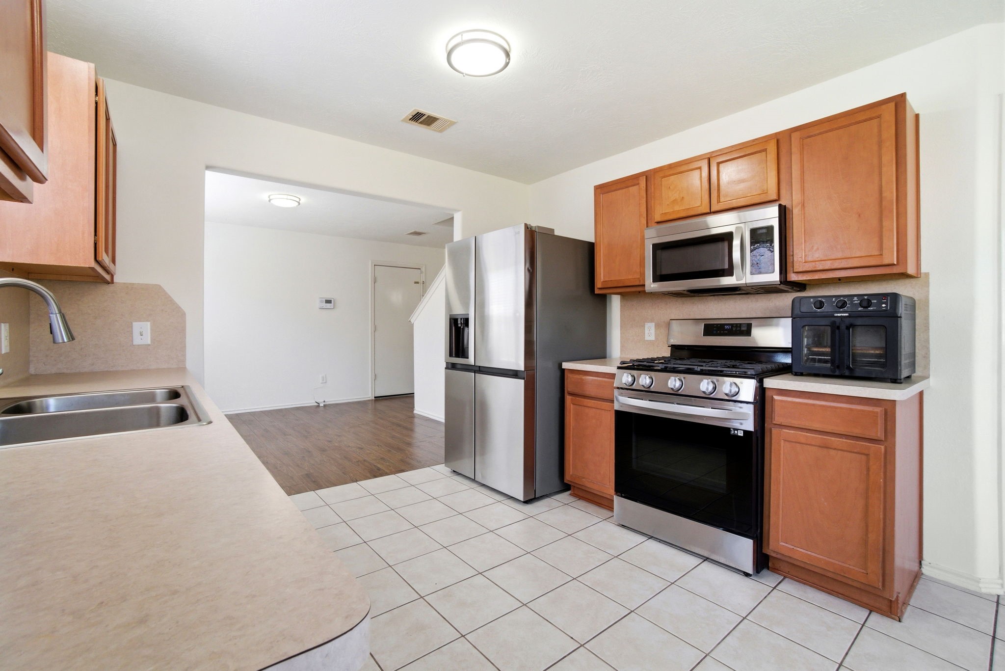 1607 Redbud Grove Court Conroe, TX 77301 - Photo 7 of 21 a kitchen with stainless steel appliances granite countertop a refrigerator stove and microwave