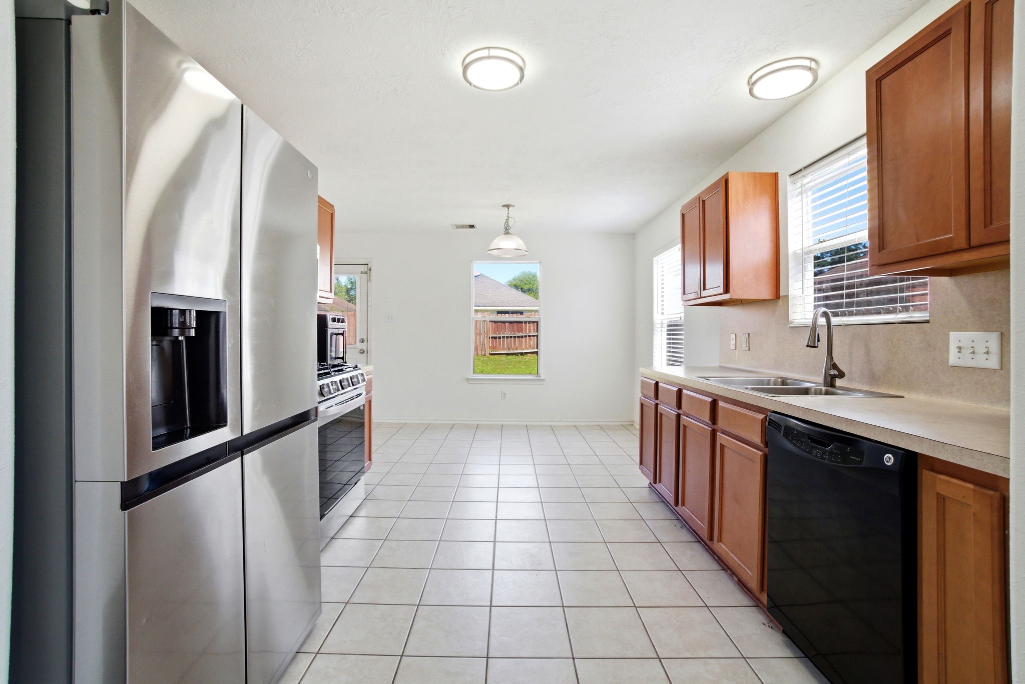1607 Redbud Grove Court Conroe, TX 77301 - Photo 8 of 21 a kitchen with stainless steel appliances granite countertop a refrigerator and a sink