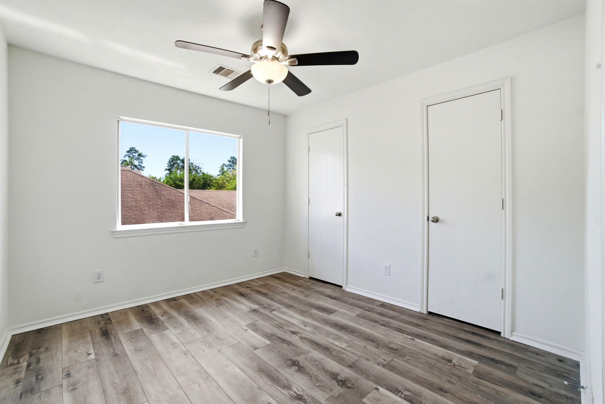 1607 Redbud Grove Court Conroe, TX 77301 - Photo 9 of 21 wooden floor in an empty room with a window