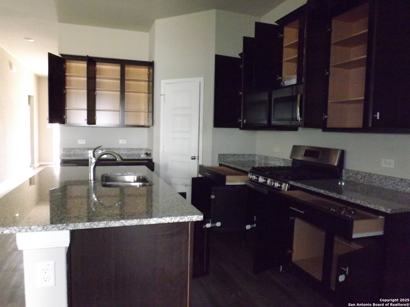 6722 Shiraz Way Converse, TX 78109 - Photo 25 of 30 a kitchen with a sink a stove and cabinets