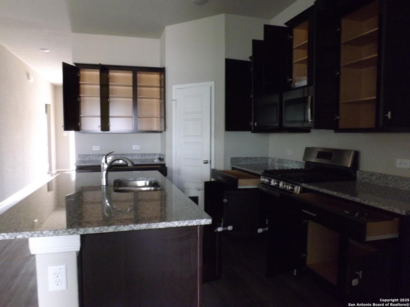 6722 Shiraz Way Converse, TX 78109 - Photo 26 of 30 a kitchen with a sink stove top oven and cabinets