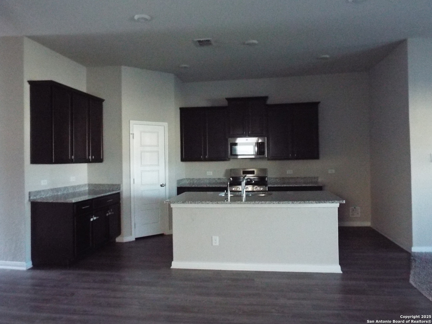 6722 Shiraz Way Converse, TX 78109 - Photo 4 of 30 a kitchen with stainless steel appliances granite countertop a sink stove and wooden floor