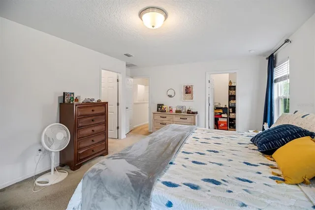 a bedroom with a bed and dresser