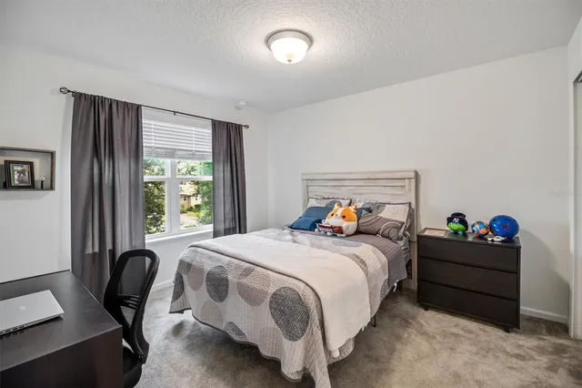 a large kitchen with kitchen island a stove a sink a dining table and chairs