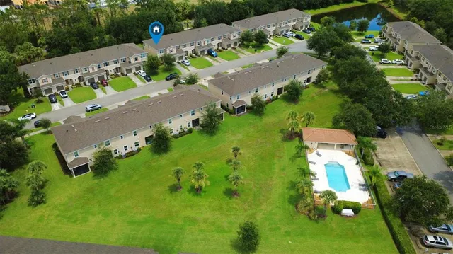 an aerial view of a house with a yard